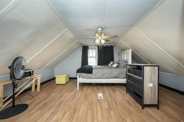 bedroom featuring ceiling fan, vaulted ceiling, and wood finished floors