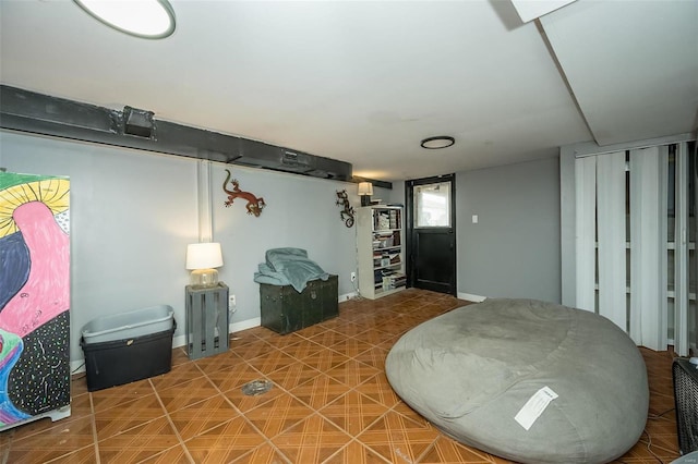 basement with baseboards and tile patterned floors