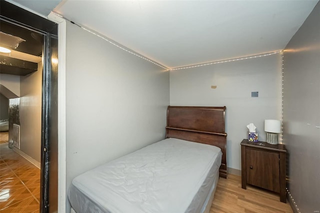 bedroom featuring light wood-style floors and baseboards