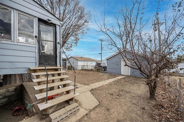 view of yard featuring a garage and entry steps