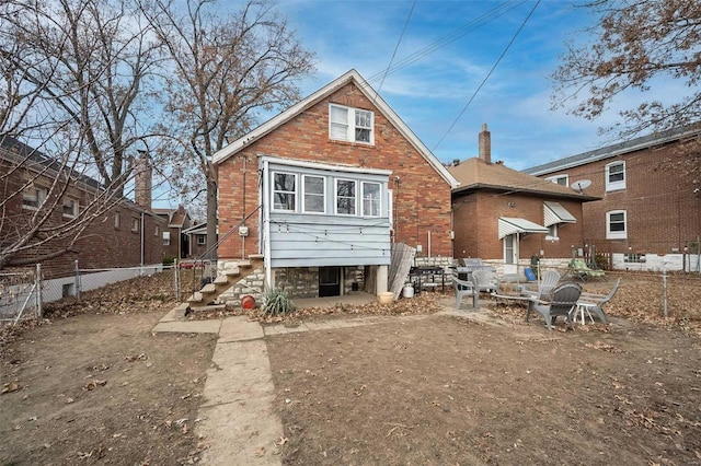 back of house with fence and brick siding