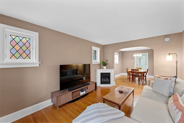 living room with an inviting chandelier and hardwood / wood-style floors