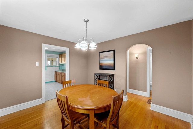 dining room featuring light hardwood / wood-style flooring and an inviting chandelier