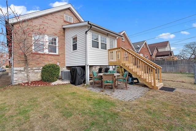 rear view of property with a patio area, a lawn, and central AC