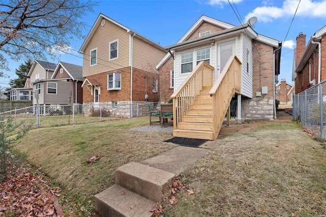 rear view of property featuring a yard