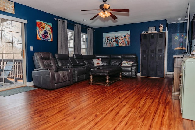 living room featuring a healthy amount of sunlight, ceiling fan, and wood-type flooring