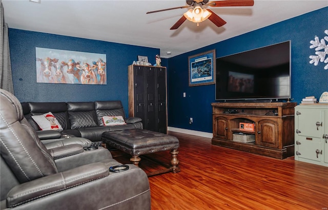 living room featuring wood-type flooring and ceiling fan