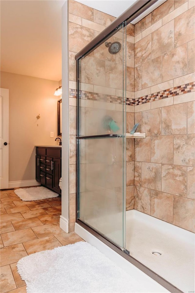 bathroom featuring sink and a shower with door