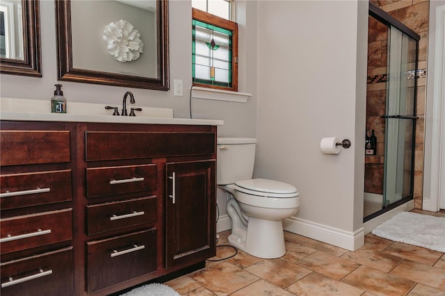 bathroom featuring vanity, an enclosed shower, and toilet