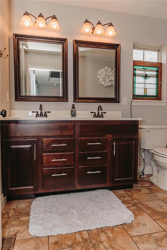 bathroom with tile patterned flooring, vanity, and toilet