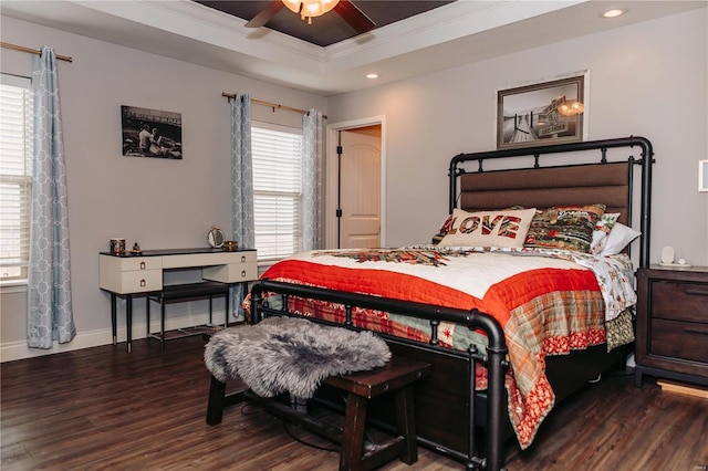 bedroom with hardwood / wood-style floors, a tray ceiling, ornamental molding, and ceiling fan