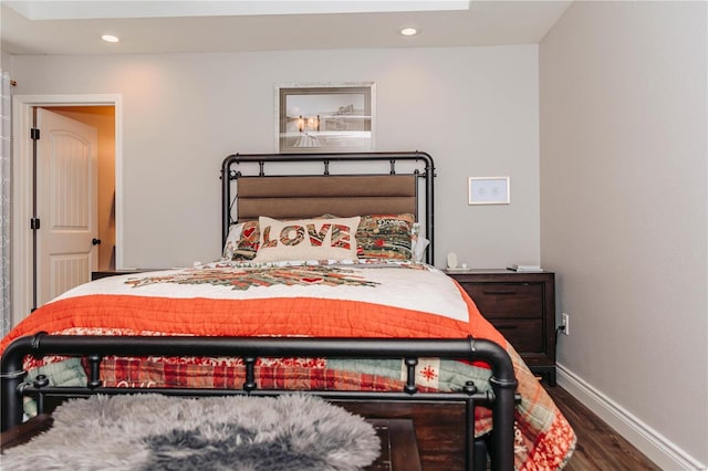 bedroom with dark hardwood / wood-style floors