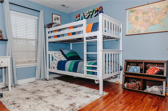 bedroom with hardwood / wood-style floors