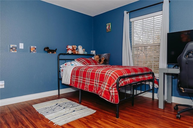 bedroom with hardwood / wood-style flooring