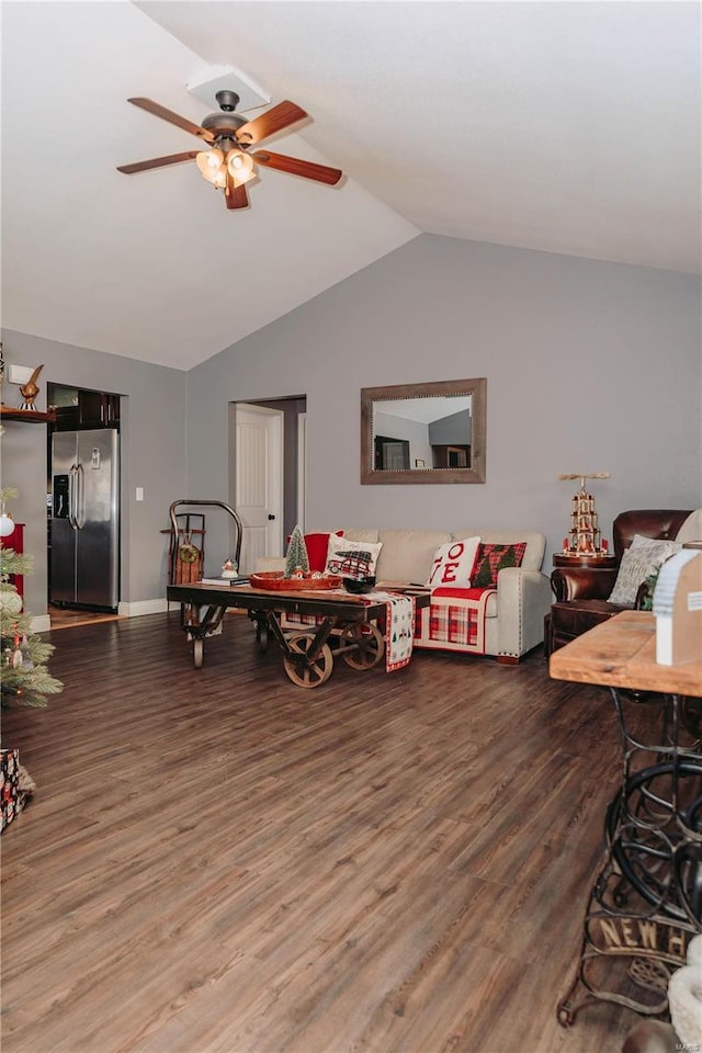 living room featuring hardwood / wood-style flooring, vaulted ceiling, and ceiling fan