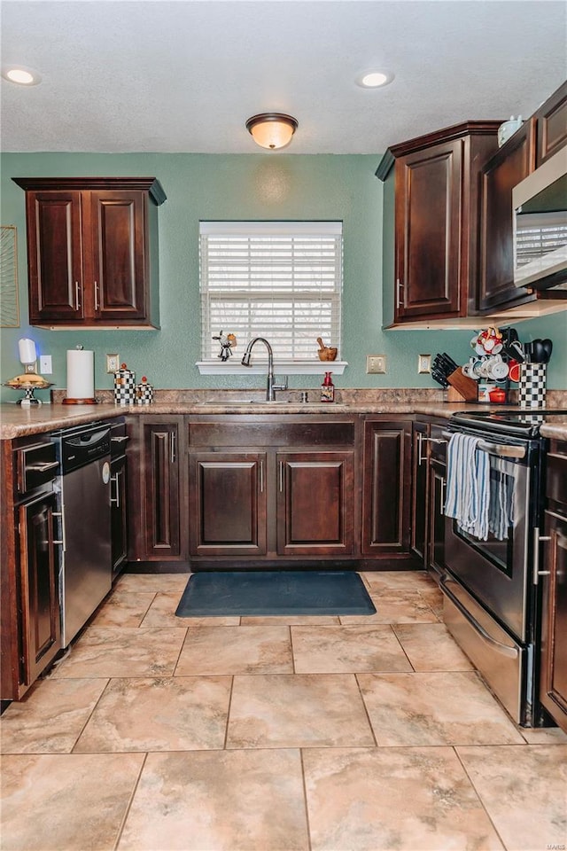 kitchen featuring dark brown cabinetry, sink, and appliances with stainless steel finishes