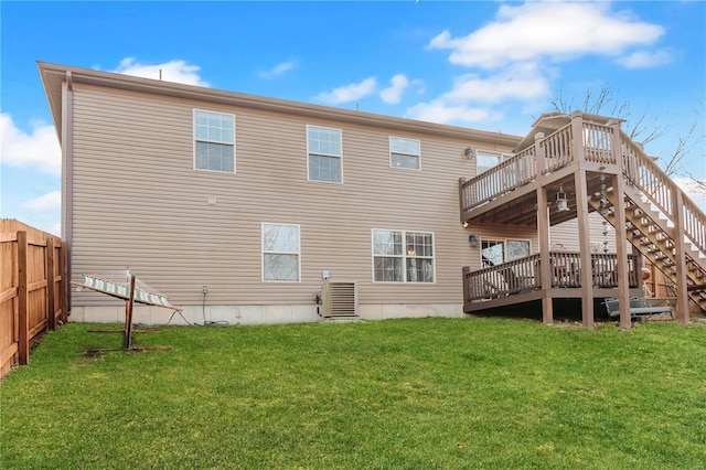 back of house featuring a wooden deck, a lawn, and cooling unit