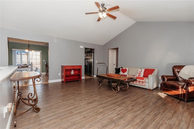 sitting room featuring ceiling fan with notable chandelier, lofted ceiling, baseboards, and wood finished floors