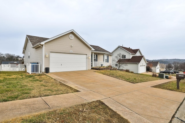 ranch-style home with cooling unit, a front lawn, and a garage