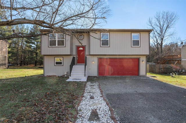 bi-level home featuring a garage and a front yard