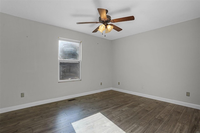 spare room with dark hardwood / wood-style flooring and ceiling fan