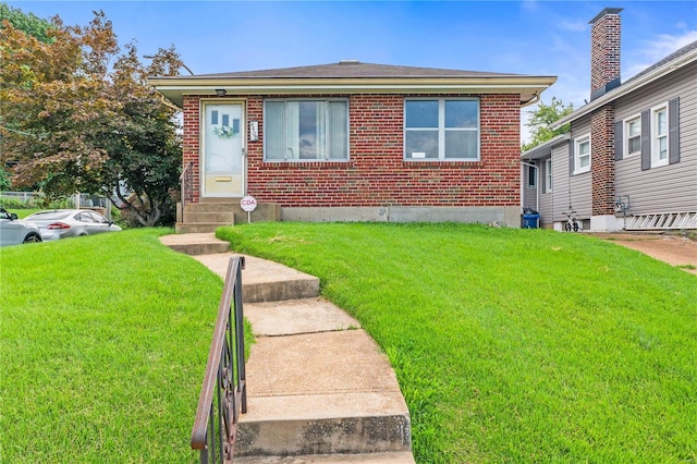 bungalow-style home featuring a front lawn