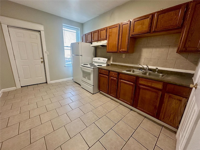 kitchen with decorative backsplash, white appliances, sink, and light tile patterned floors