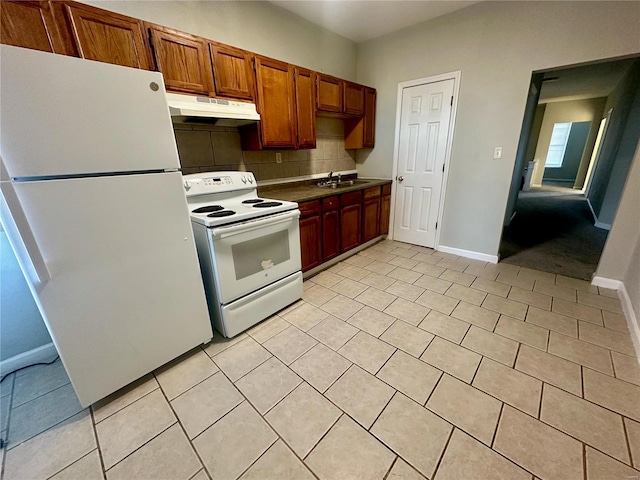 kitchen featuring decorative backsplash, sink, light tile patterned flooring, and white appliances