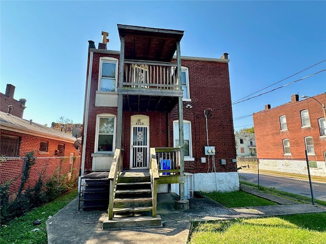 view of front of house featuring a balcony