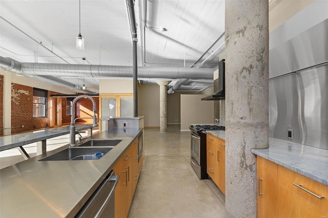 kitchen featuring ornate columns, light stone countertops, sink, hanging light fixtures, and appliances with stainless steel finishes