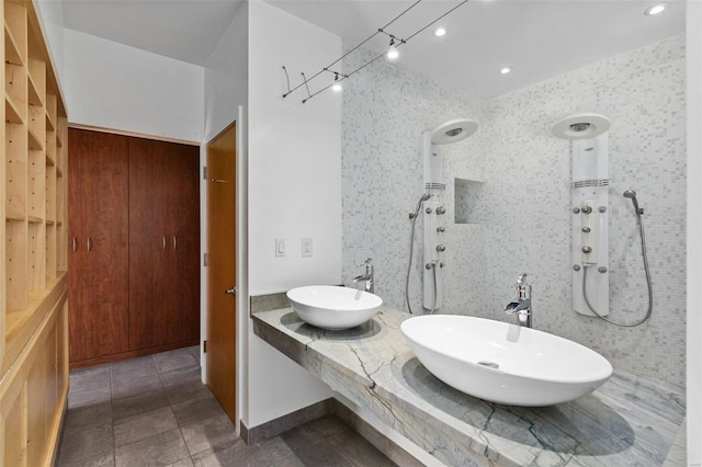 bathroom featuring a tile shower and sink