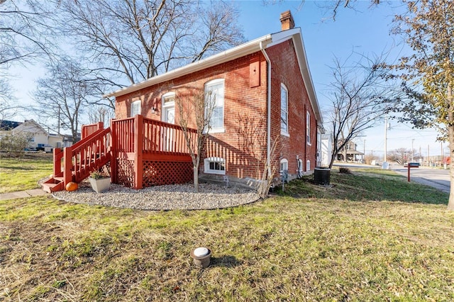 view of side of home with a lawn