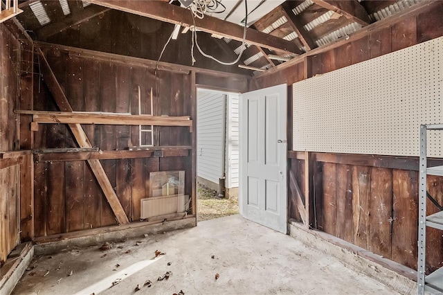 interior space with concrete floors and vaulted ceiling