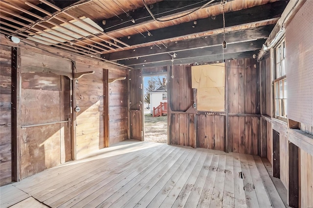 miscellaneous room featuring wood walls and light hardwood / wood-style flooring