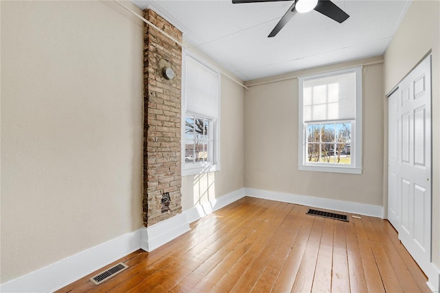 unfurnished bedroom with ceiling fan, a closet, and wood-type flooring