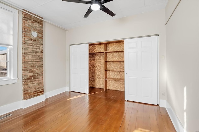 unfurnished bedroom with a closet, ceiling fan, and hardwood / wood-style floors