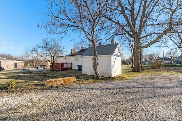 view of property exterior with a wooden deck