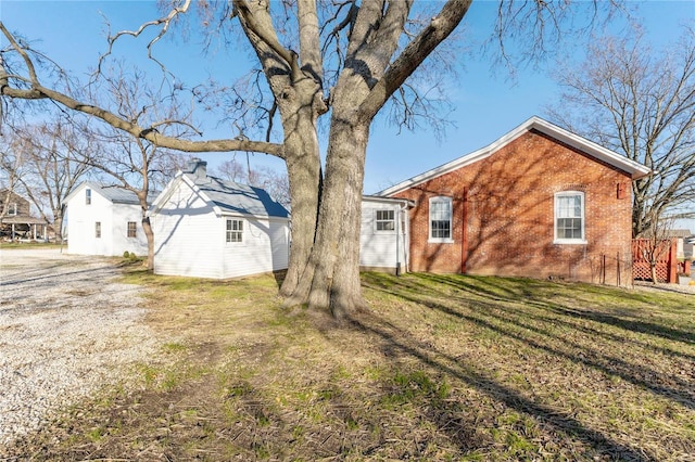 back of house featuring a lawn