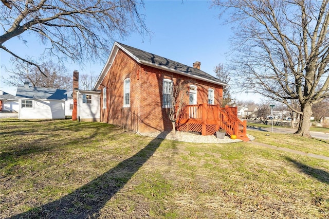 rear view of house featuring a lawn