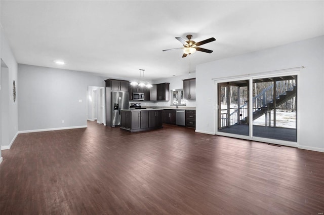 unfurnished living room with sink, ceiling fan, and dark hardwood / wood-style floors