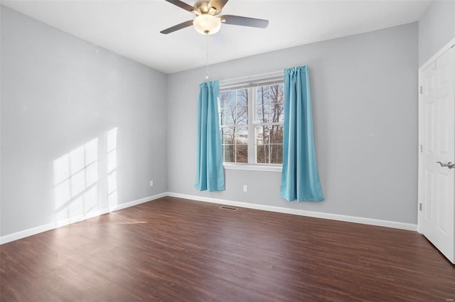 unfurnished room featuring ceiling fan and dark hardwood / wood-style floors