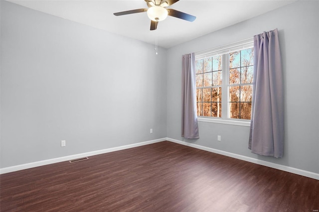 empty room with ceiling fan and dark wood-type flooring