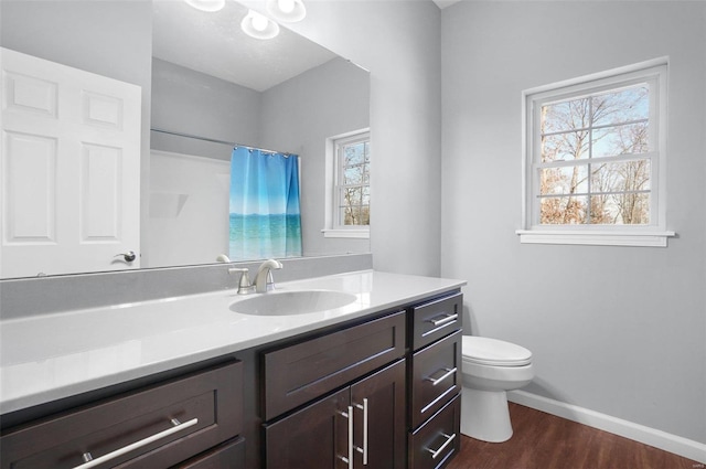 bathroom with wood-type flooring, toilet, vanity, and a shower with curtain