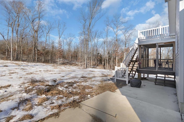 yard covered in snow with a patio