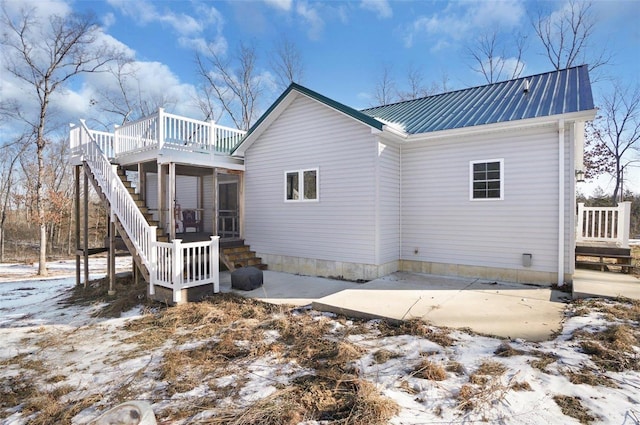 snow covered property with a sunroom