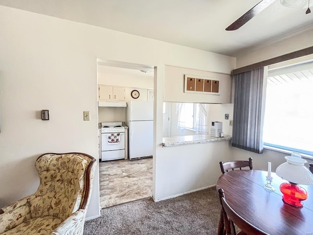 kitchen with carpet, white appliances, ceiling fan, and a healthy amount of sunlight