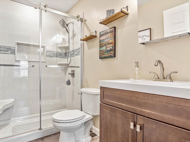 bathroom featuring hardwood / wood-style floors, vanity, toilet, and an enclosed shower