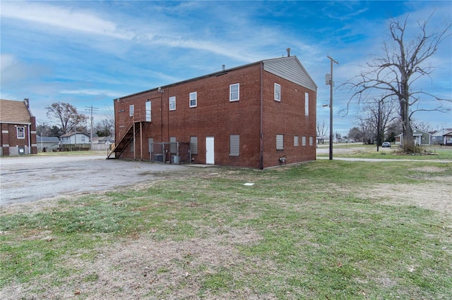 view of property exterior with a lawn