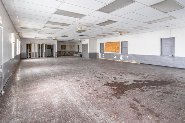 spare room featuring a drop ceiling and ceiling fan