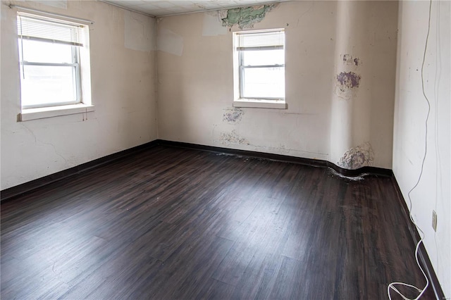 empty room with dark hardwood / wood-style floors